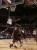 A&M's forward Khris Middleton leaps over guard Dash Harris to lay in a basket.