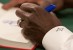 A close-up of Herman Cain's hand as he signs a copy of his book.