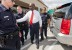 Herman Cain leaves his book signing in College Station, TX surrounded by 3 police officers.